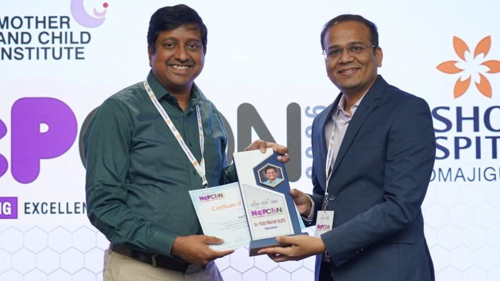 Dr. Raghupathi with a smiling child